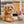 Load image into Gallery viewer, P.L.A.Y.&#39;s Forest Friends Collection - Baxter the Bunny Toy beside a fluffy dog on a rug in front of a sliding glass door
