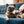 Load image into Gallery viewer, P.L.A.Y. Puppy Love Collection - Barking Bubbly Toy tip of bottle in Frenchie&#39;s mouth on a blue couch
