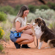 Load image into Gallery viewer, Landscape Series Deluxe Training Pouch in River around human's waist while she holds her dog's paw on a desert trail