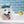Load image into Gallery viewer, P.L.A.Y. Splish Splash Collecton - Shower Quack Toy on top of fluffy dog&#39;s head with tongue out in bathtub with blue tile
