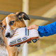 Load image into Gallery viewer, P.L.A.Y. 80s Classics Scruffy's Station Waggin' Toy - human holding onto one side with dog's mouth on the back half of the car