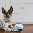 Load image into Gallery viewer, P.L.A.Y. Snack Attack Collection - Mini Fluffles Toy sitting on the paws of a small dog on a kitchen floor looking at the camera