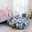 Load image into Gallery viewer, Mosaic Lounge Bed by P.L.A.Y. in Tuxedo with dog laying in it at foot of bed in bedroom