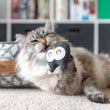 Load image into Gallery viewer, P.L.A.Y. Feline Frenzy Hooti-ful Owls Toy Set - lifestyle image with the doopy tweed owl being  bit by a fluffy kitty in front of a bed and bookcase