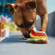 Load image into Gallery viewer, P.L.A.Y.'s International Classic Tail Waggin' Taco Toy - brown dog sniffing the taco with nose between the layers