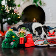 Load image into Gallery viewer, Merry Woofmas Toy Set with dog in P.L.A.Y. Lounge Bed in front of Christmas Tree and fire place