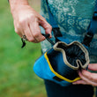 Load image into Gallery viewer, Landscape Series Deluxe Training Pouch in River women closing the treat pouch drawstring