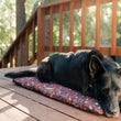 Load image into Gallery viewer, Scout & About Outdoor Chill Pad in Mocha with dog sleeping on it outside on a deck