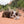 Load image into Gallery viewer, P.L.A.Y. Big Five of Africa Collection - Rhino Toy on a sandy trail in Utah where a dog is laying down chewing on it&#39;s tail during playtime
