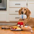 Load image into Gallery viewer, IHOP x P.L.A.Y. Breakfast Sampler Collab - all four toys shown on kitchen floor with brown dog holding coffee mug handle in its mouth
