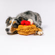 Load image into Gallery viewer, IHOP x P.L.A.Y. Thick 'N Fluffy French Toast - fluffy multi-colored dog posing with toy showing a side view on floor with smile on its face
