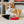Load image into Gallery viewer, P.L.A.Y. Feline Frenzy Killer Cat Deadly Duo Toy Set - dagger toy in front of ginger cat with claws dug into it
