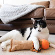 Load image into Gallery viewer, P.L.A.Y. Feline Frenzy Halloween Kicker Toy - Scaredy Crow underneath paw of black and white kitten laying in living room
