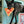 Load image into Gallery viewer, P.L.A.Y. Snack Attack Collection - Puppy-roni Pizza Toy in beautiful black dog&#39;s mouth coming around kitchen island with pizza box on ground
