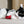 Load image into Gallery viewer, P.L.A.Y. Feline Frenzy Twice As Mice Toy Set - black and white cat laying down nibbling on the crunchy tail of the red mouse toy

