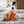 Load image into Gallery viewer, Holiday Classic Collection by P.L.A.Y. - Holly Jolly Gingerbread Man Toy leaning up against white dog laying in a Moroccan Lounge Bed
