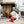 Load image into Gallery viewer, Holiday Classic Collection by P.L.A.Y. - Ho Ho Ho Hot Chocolate Toy with white lab nosing the top of it under the dining room table
