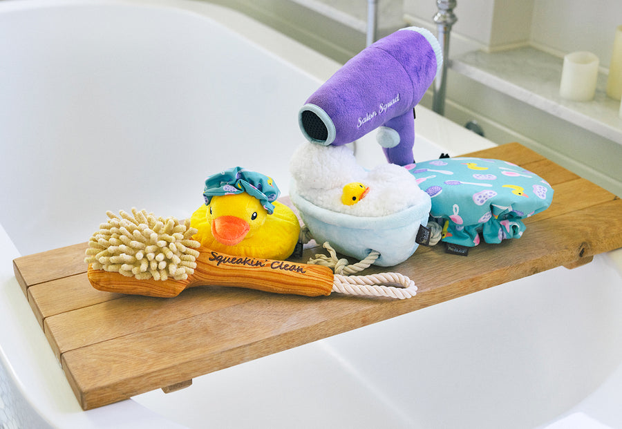 P.L.A.Y. Splish Splash Collection - five bath-themed toys on rustic tray over white bathtub