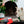 Load image into Gallery viewer, P.L.A.Y. Merry Woofmas Good Dog Stocking - black and white dog laying on Chill Pad with bone toy in mouth

