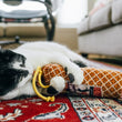 Load image into Gallery viewer, Cat playing with P.L.A.Y. Feline Frenzy Salami Slammer Kicker Toy on a red patterned rug
