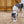 Load image into Gallery viewer, P.L.A.Y. Barnyard Buddies Sadie the Sheep in gravel being sniffed by larger gray and white dog in front of the barn
