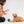 Load image into Gallery viewer, P.L.A.Y.&#39;s Picked Fresh Veggie Munch Duo Toy Set: Dog Mom interacting with a dog by inserting a treat into pocket on bottom of cauliflower toy with dog staring up at her on a white background
