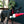 Load image into Gallery viewer, P.L.A.Y. Merry Woofmas Good Dog Stocking - beautiful black dog walking on deck with stocking toy in mouth

