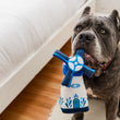 Load image into Gallery viewer, P.L.A.Y. Totally Touristy Dutch Windmill - medium size hanging out of big black dog&#39;s mouth sitting near a white bed
