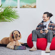 Load image into Gallery viewer, HyperX x P.L.A.Y. Pulsefur Mat - Jagger a Goldendoodle sitting on Chill Pad wearing Cloud Arfa Gaming Headset with dog dad smiling down from red bean bag chair while gaming
