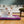 Load image into Gallery viewer, Coastal Series Original Chill Pad in Plum with dog laying on it with eyes closed in living room
