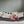 Load image into Gallery viewer, P.L.A.Y. Canine Commute Lickety-Split Bus - white dog laying on couch with head propped up on roof of the bus toy deep in thought about playtime
