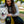Load image into Gallery viewer, Proper Pup Poop Bag Dispensers from P.L.A.Y. - Kalahari Black on yellow leash being held by human as she smiles at her fluffy white dog also smiling
