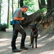 Load image into Gallery viewer, P.L.A.Y.&#39;s Explorer Pack in Waterfall Blue on man smiling down at beautiful black dog on a hike
