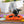 Load image into Gallery viewer, P.L.A.Y. Snuffle Mat - Halloween-themed with dog on porch hunting for treats in pumpkin
