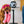 Load image into Gallery viewer, Dog with hot pink glasses on holding cord of 80s Classics Toy Collection by P.L.A.Y. Paw Talk toy from mouth
